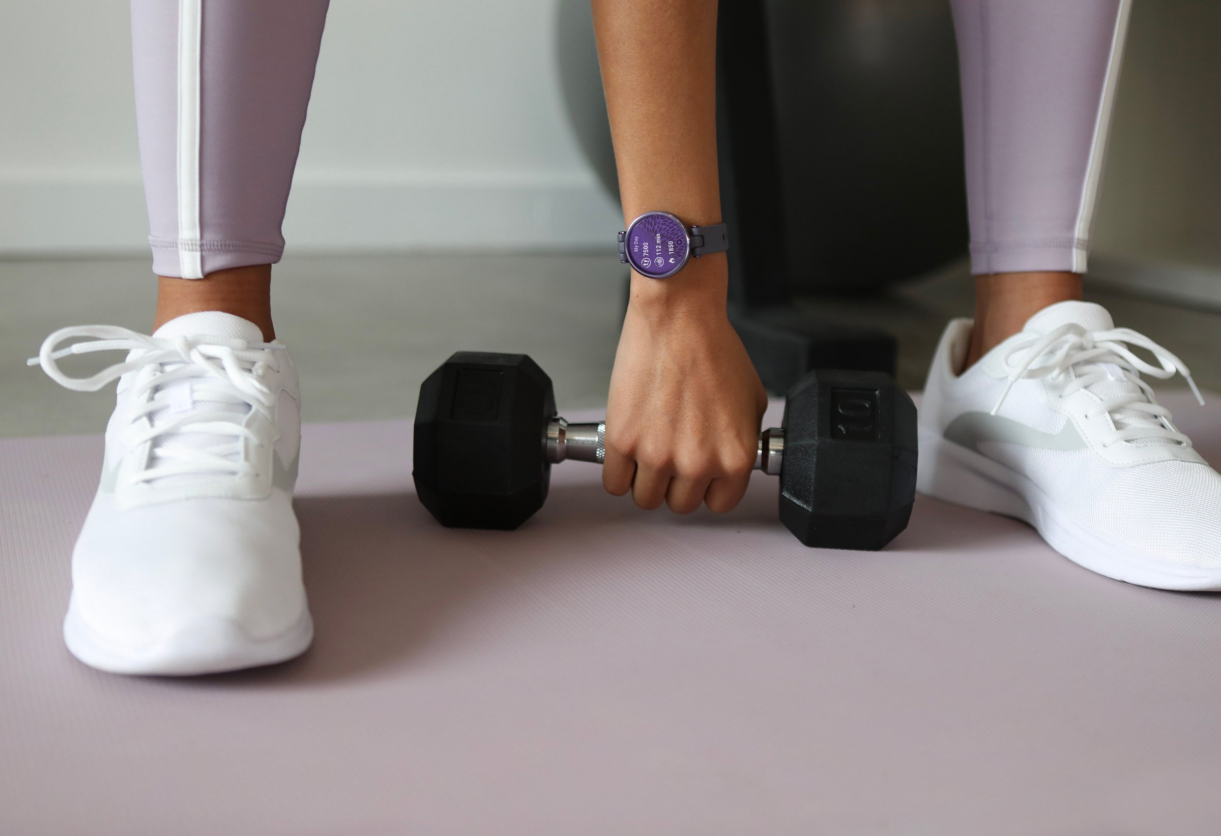 picture of woman wearing a sport watch while working out. 